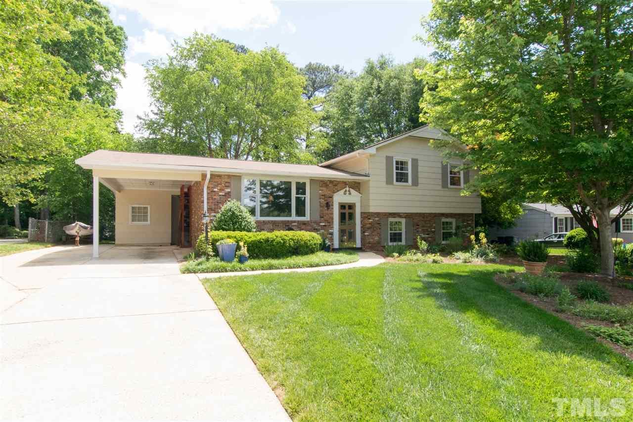4708 Rampart Street Raleigh, NC 27609 - Photo 2 of 25 a front view of a house with a yard and trees