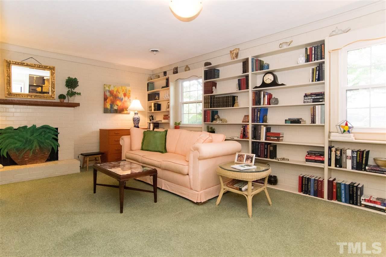 4708 Rampart Street Raleigh, NC 27609 - Photo 11 of 25 a living room with furniture and a book shelf