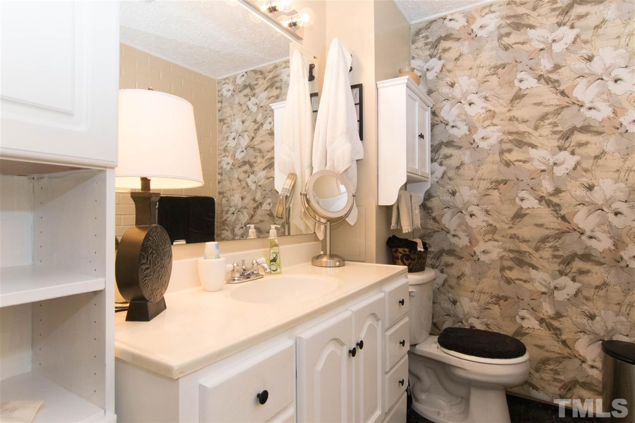 4708 Rampart Street Raleigh, NC 27609 - Photo 15 of 25 a bathroom with a sink and a toilet