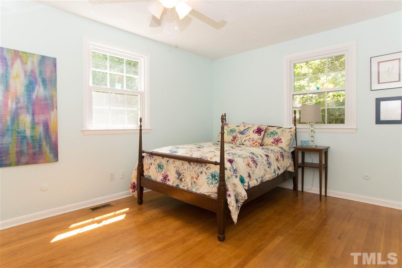 4708 Rampart Street Raleigh, NC 27609 - Photo 16 of 25 a bed sitting in a bedroom next to a window