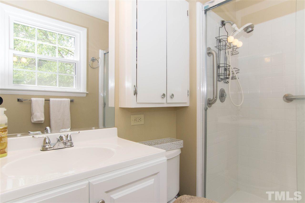 4708 Rampart Street Raleigh, NC 27609 - Photo 17 of 25 a bathroom with a sink and a mirror