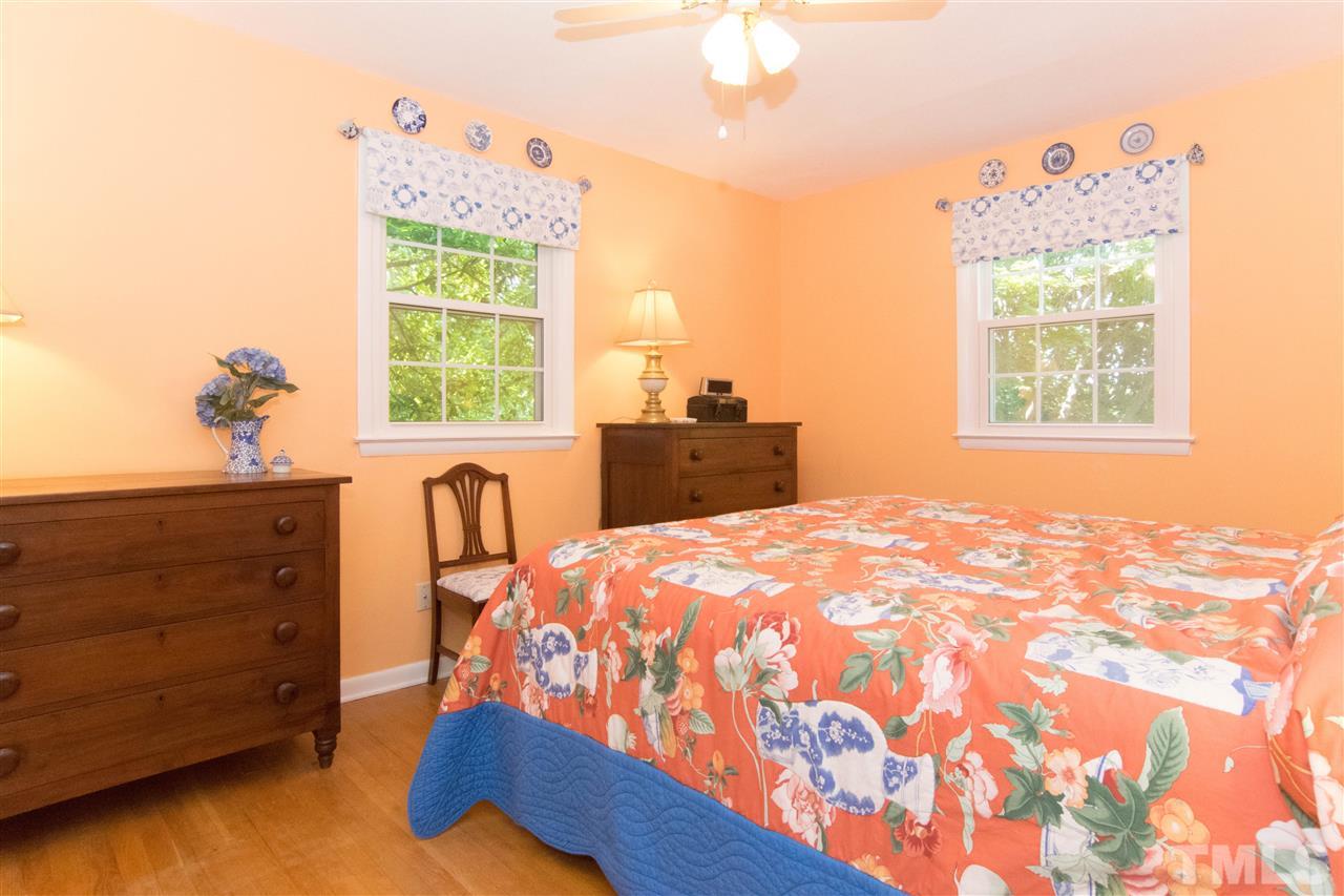4708 Rampart Street Raleigh, NC 27609 - Photo 18 of 25 a bed sitting in a bedroom next to a window