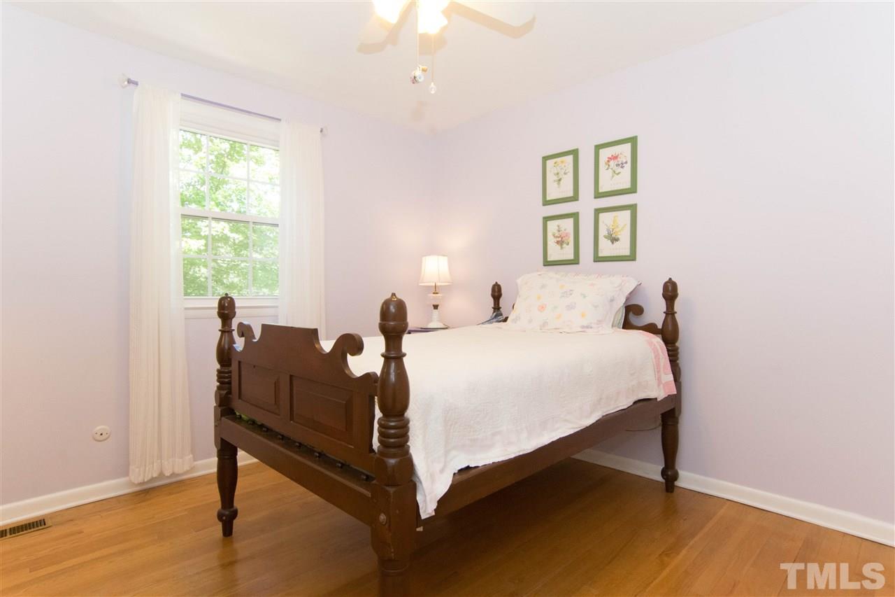 4708 Rampart Street Raleigh, NC 27609 - Photo 19 of 25 a bedroom with a bed and a window