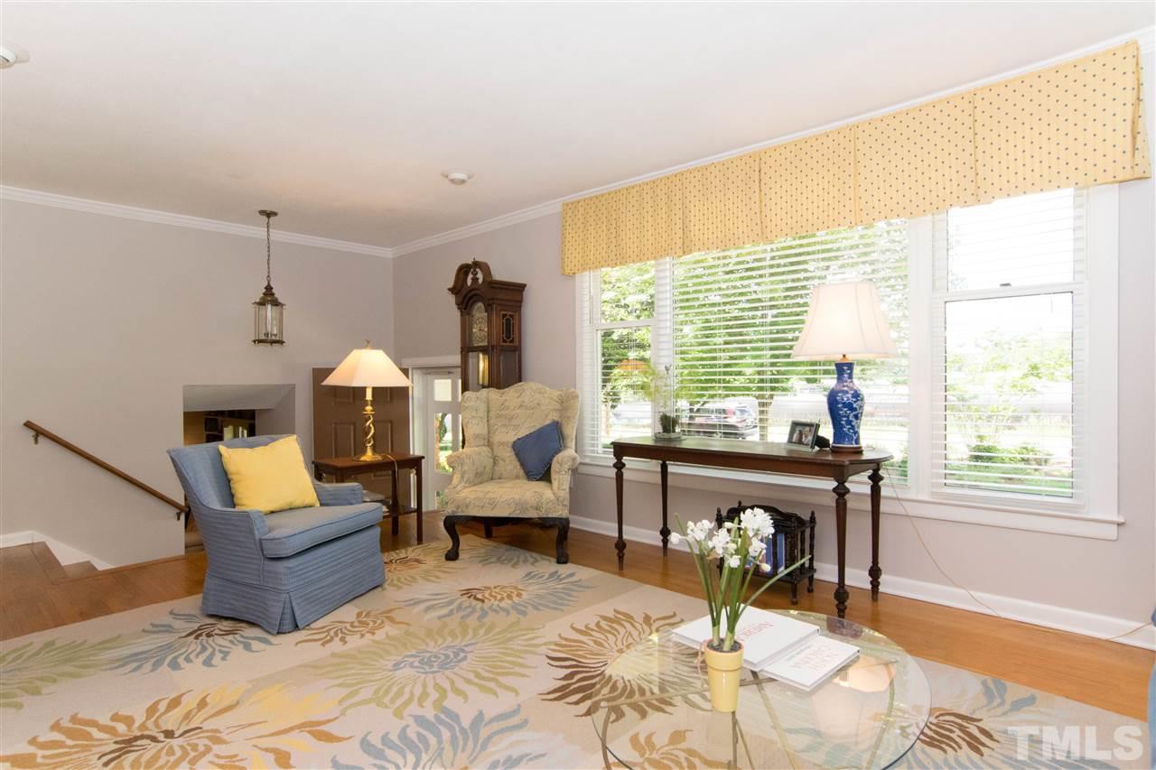 4708 Rampart Street Raleigh, NC 27609 - Photo 3 of 25 a living room with furniture and a fireplace