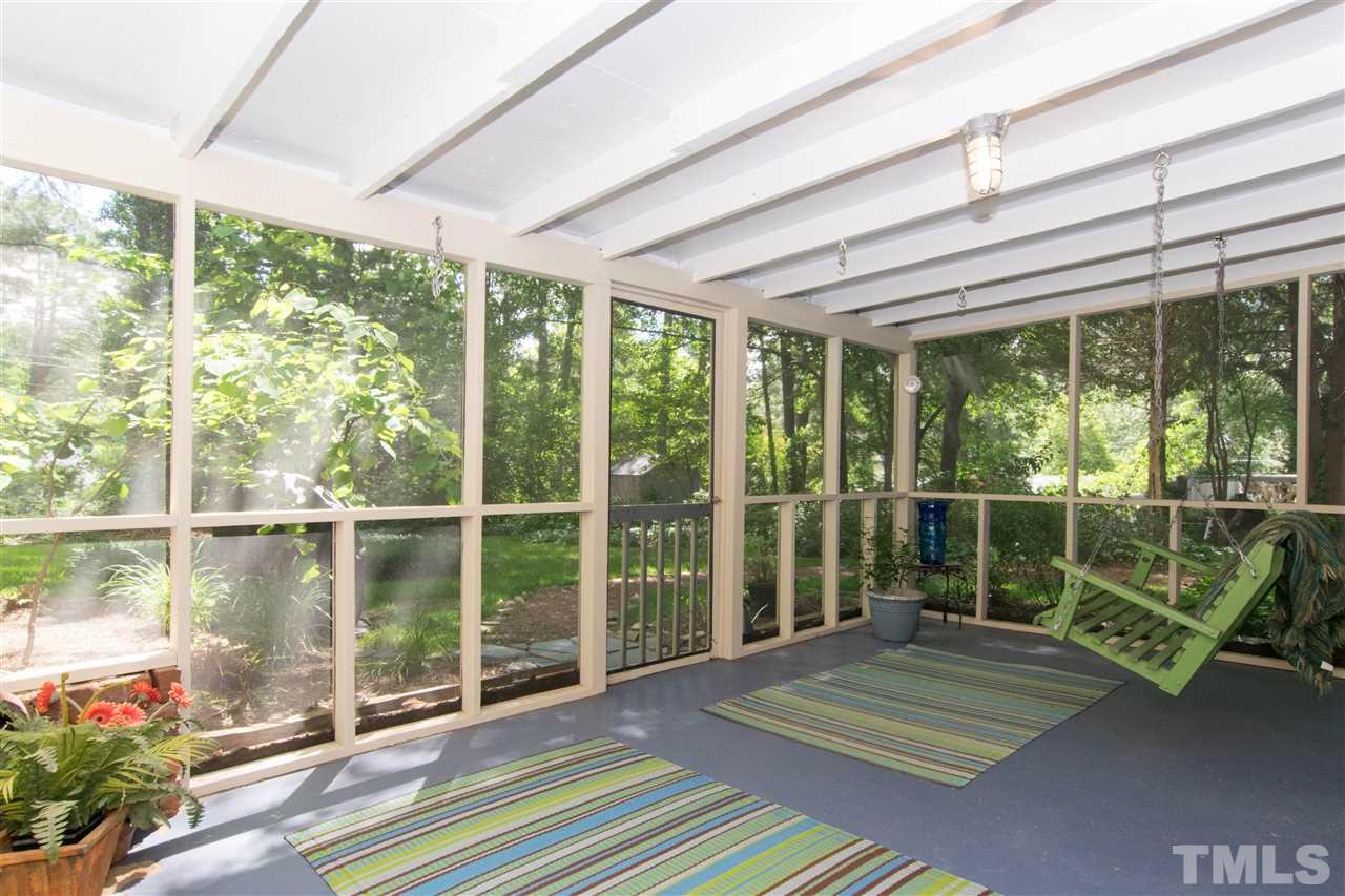 4708 Rampart Street Raleigh, NC 27609 - Photo 21 of 25 a bedroom with furniture and large windows