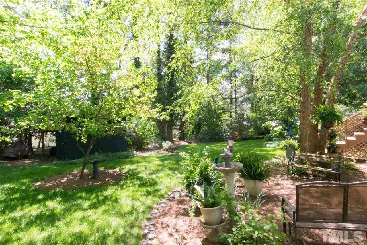 4708 Rampart Street Raleigh, NC 27609 - Photo 22 of 25 a backyard of a house with lots of green space