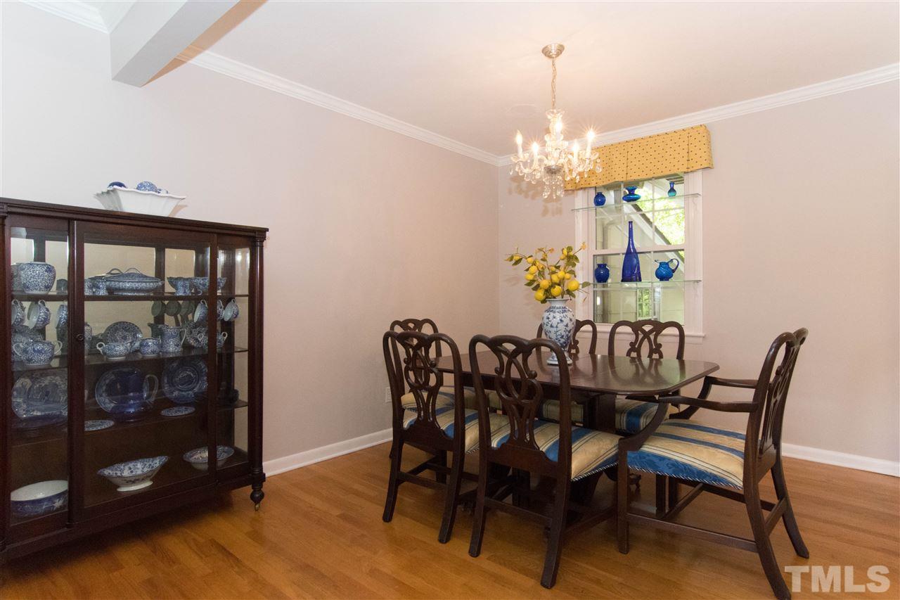 4708 Rampart Street Raleigh, NC 27609 - Photo 4 of 25 a view of a dining room with furniture and chandelier