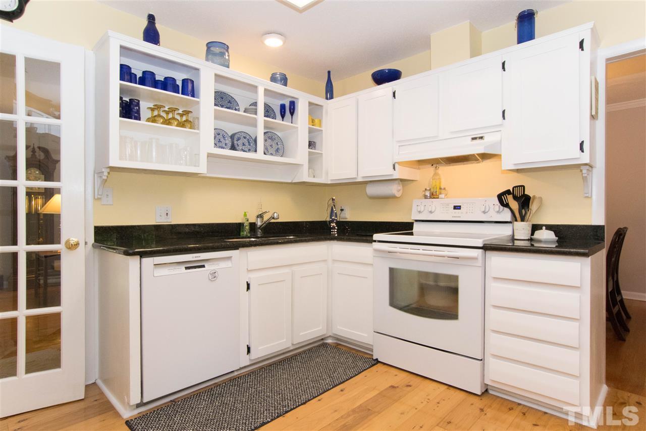 4708 Rampart Street Raleigh, NC 27609 - Photo 5 of 25 a kitchen with stainless steel appliances granite countertop a sink and cabinets