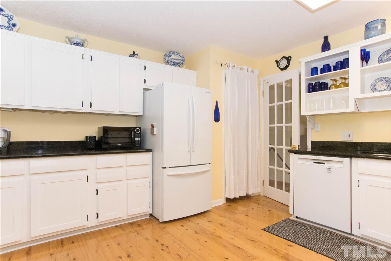 4708 Rampart Street Raleigh, NC 27609 - Photo 6 of 25 a kitchen with stainless steel appliances a refrigerator and a stove