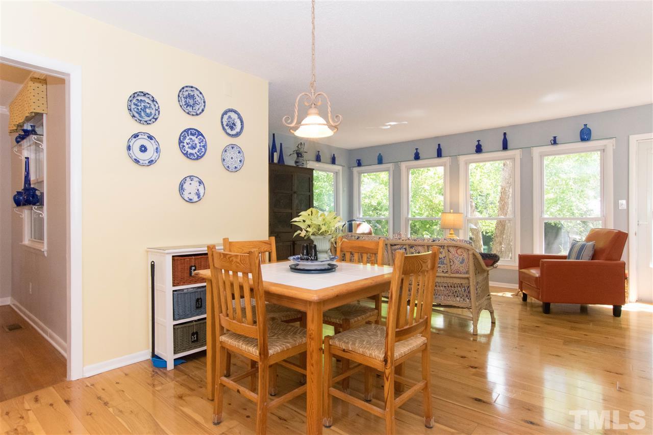 4708 Rampart Street Raleigh, NC 27609 - Photo 9 of 25 a view of a dining room with furniture window and wooden floor