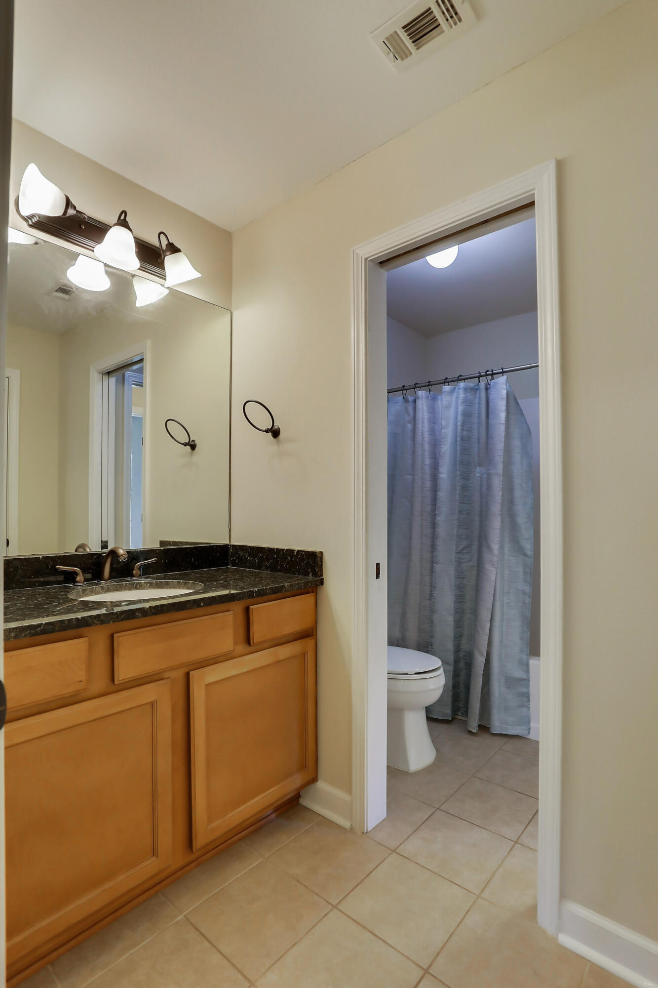 4581 Hermosa Road Crestview, FL 32539 - Photo 54 of 60 a bathroom with a granite countertop sink and a mirror
