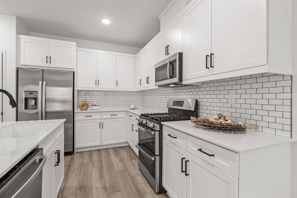 319 Minneola Place Fallbrook, CA 92028 - Photo 13 of 19 a kitchen with white cabinets stainless steel appliances and sink