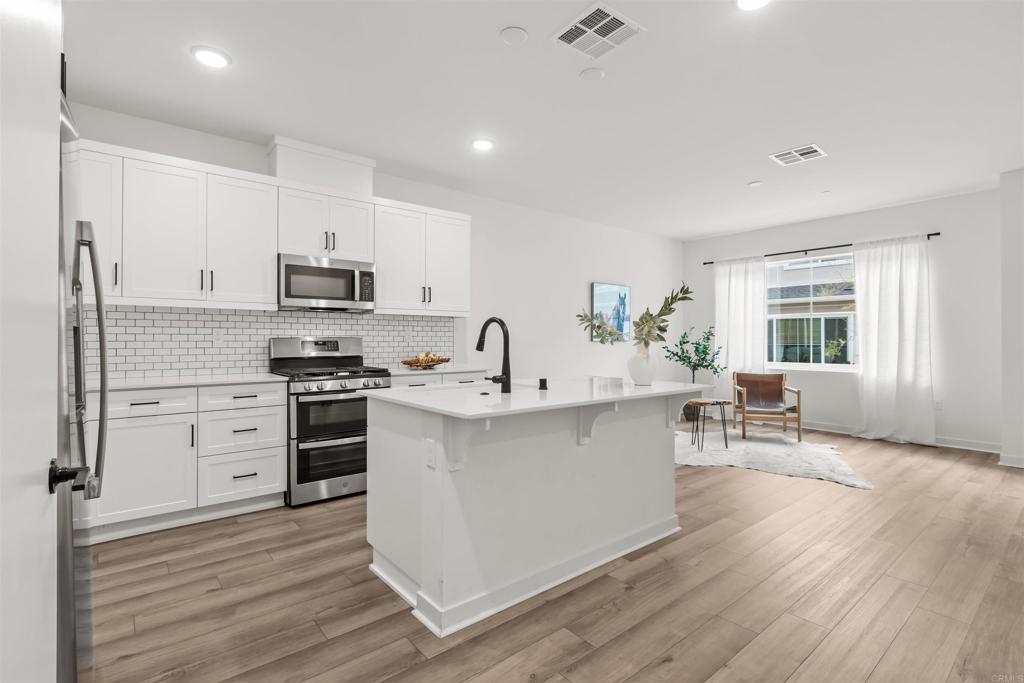 319 Minneola Place Fallbrook, CA 92028 - Photo 10 of 19 a kitchen with stainless steel appliances a sink stove and cabinets