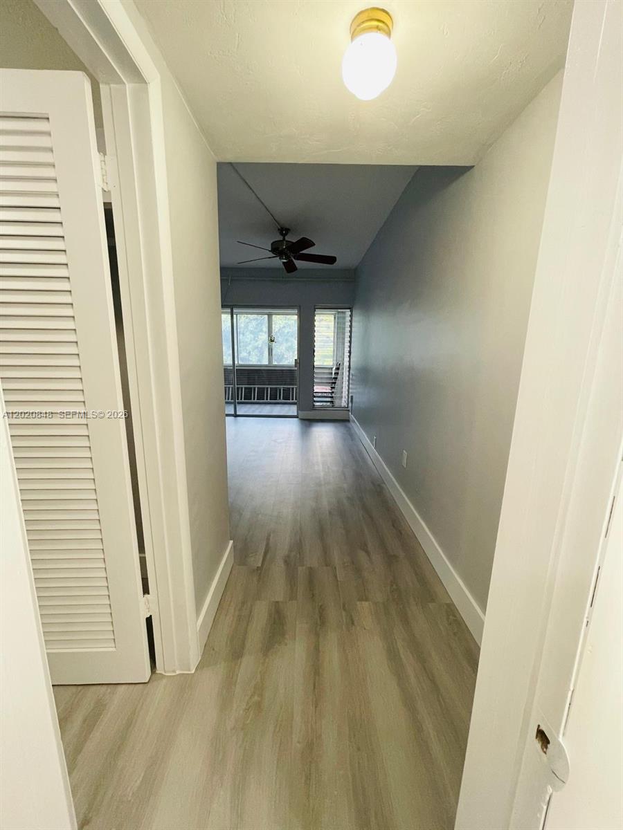9175 Southwest 77th Avenue, Unit 306 Miami, FL 33156 - Photo 10 of 16 a view of a hallway with wooden floor