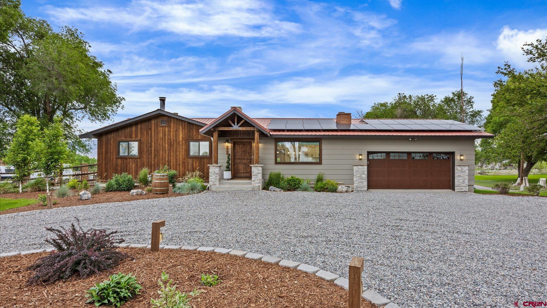 1761 G Road Delta, CO 81416 - Photo 32 of 43 a front view of a house with a yard and garage