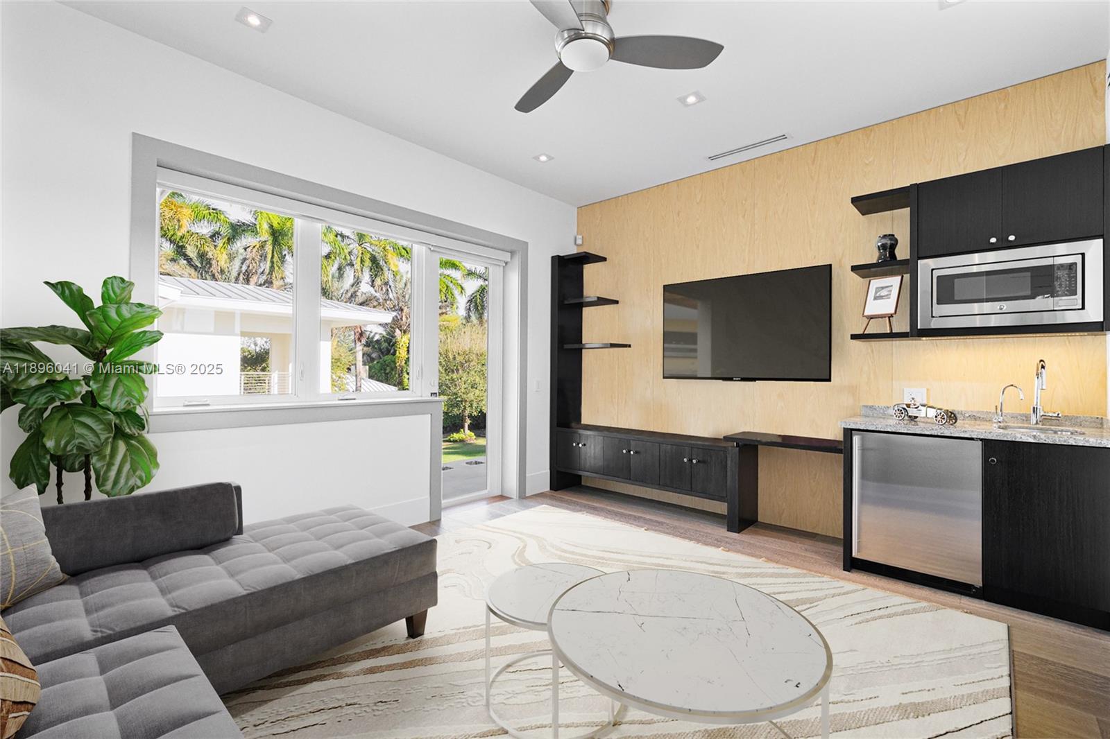 6080 Southwest 88th Street Pinecrest, FL 33156 - Photo 14 of 29 a living room with furniture and a flat screen tv