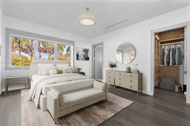 a bedroom with a bed and a large window