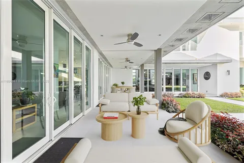 a view of a patio with swimming pool and furniture
