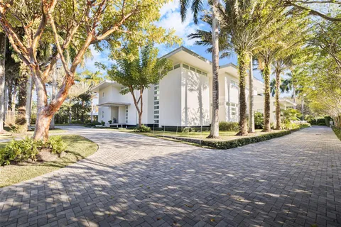 a view of a house with snow on the road