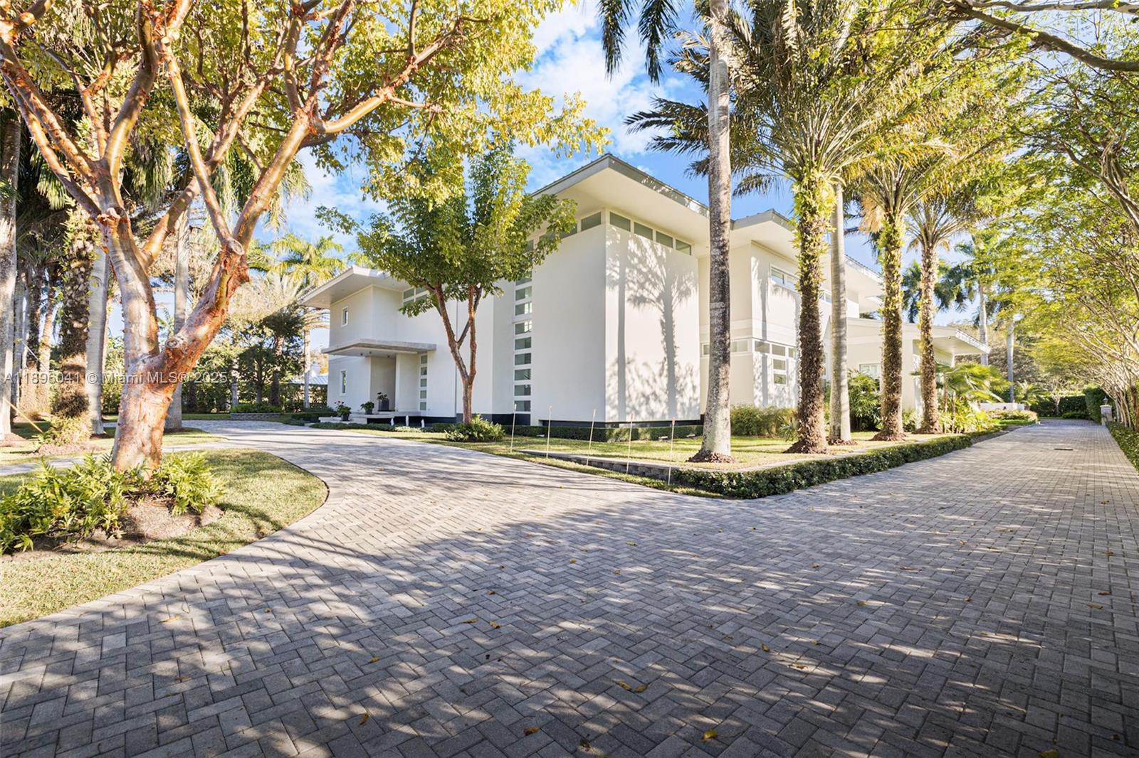 6080 Southwest 88th Street Pinecrest, FL 33156 - Photo 2 of 29 a view of a house with snow on the road