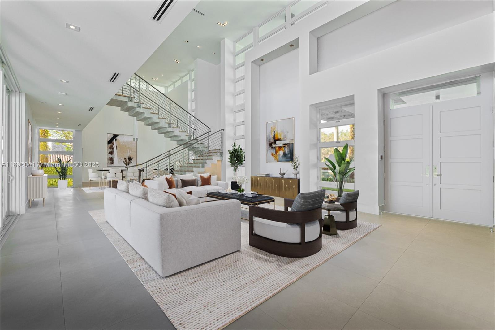 6080 Southwest 88th Street Pinecrest, FL 33156 - Photo 3 of 29 a living room with furniture and a chandelier