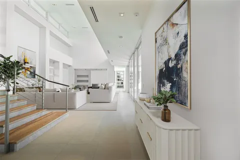 a view of entryway and hall with wooden floor