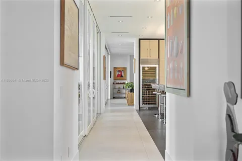 a view of a hallway with wooden shelves