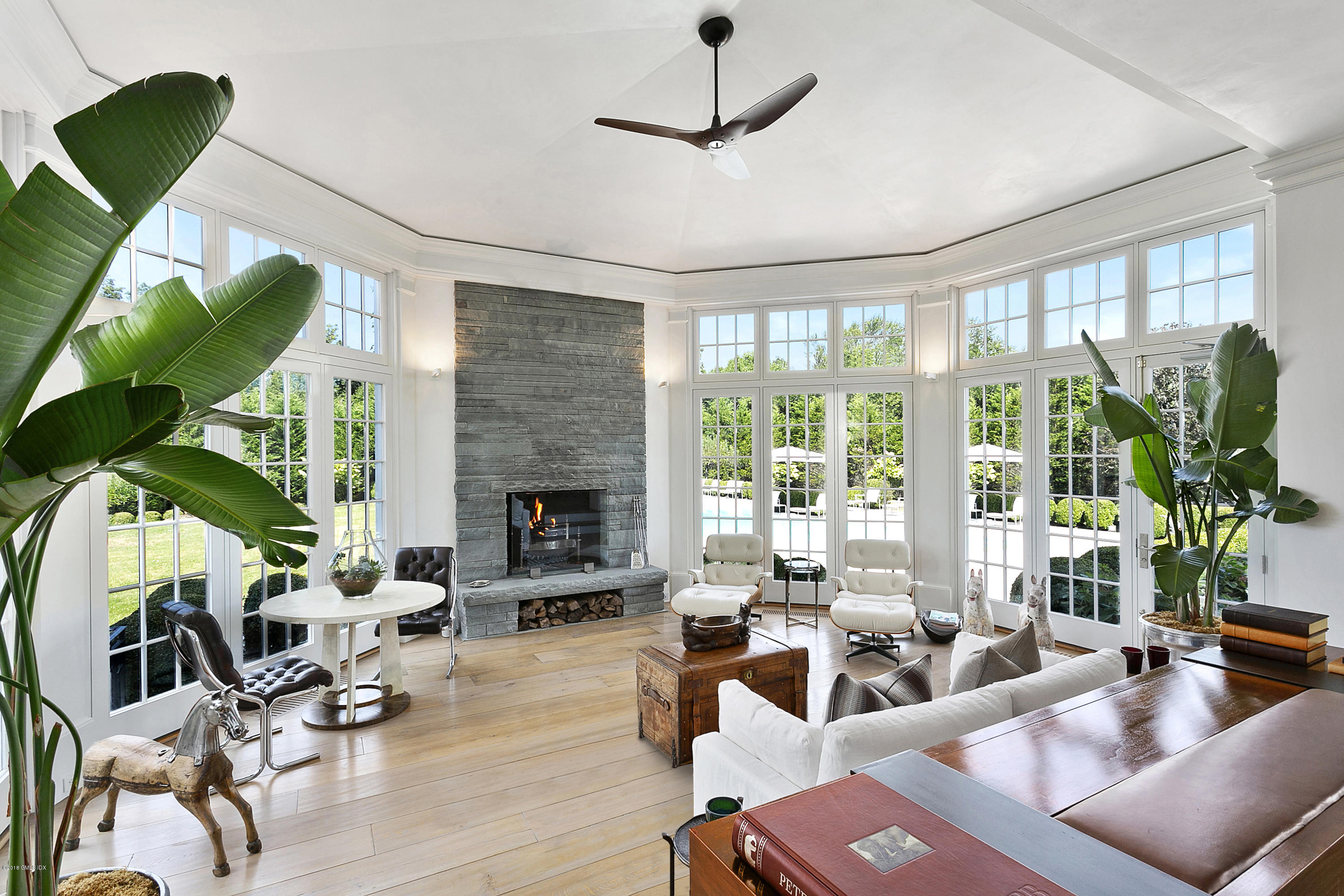 Undisclosed Address Greenwich, CT 06831 - Photo 13 of 23 a living room with furniture a potted plant and a large window