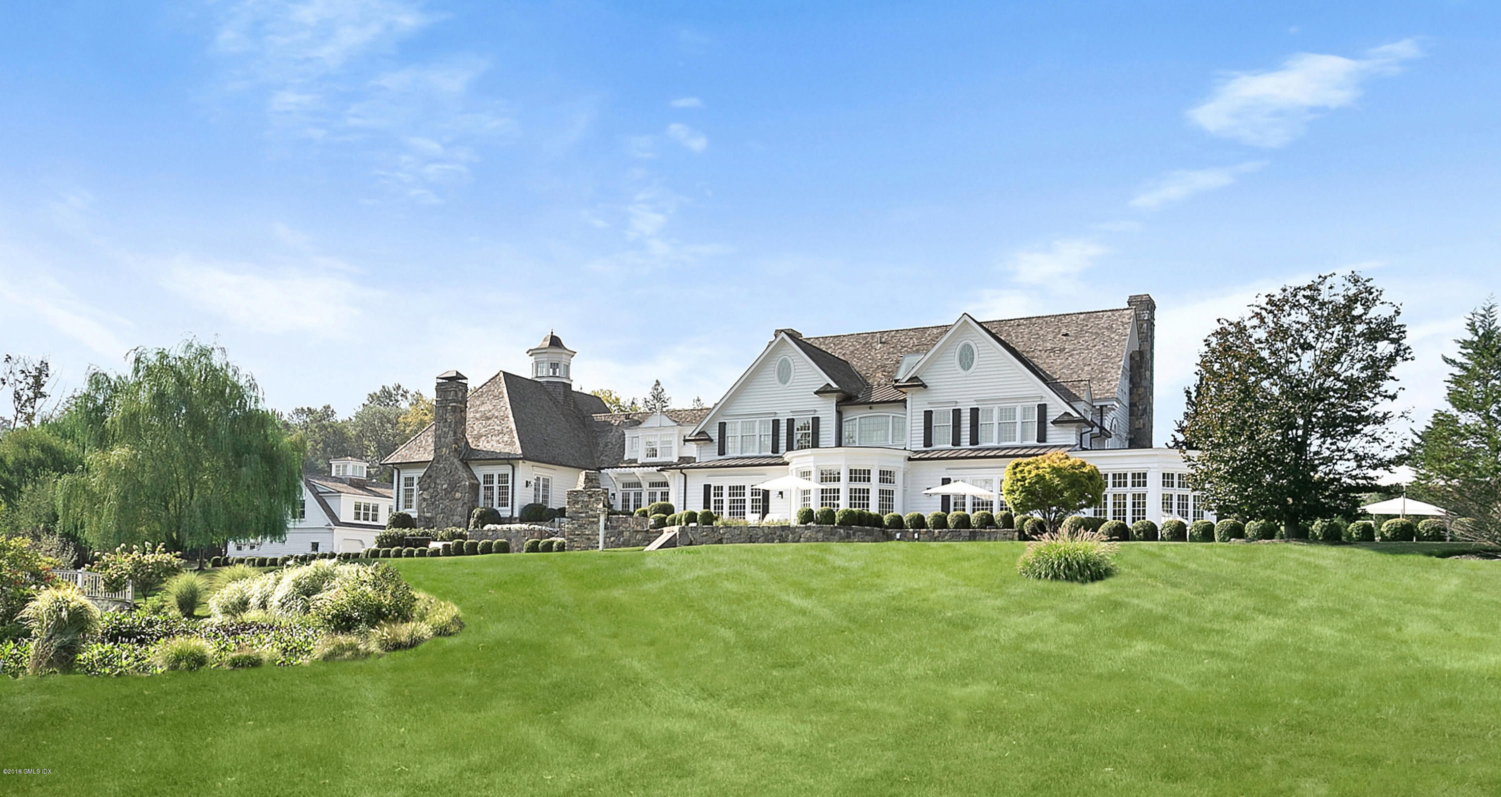 Undisclosed Address Greenwich, CT 06831 - Photo 3 of 23 a view of a house with a big yard and large trees