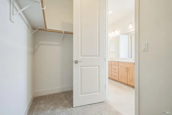an empty room with a cabinet and mirrors