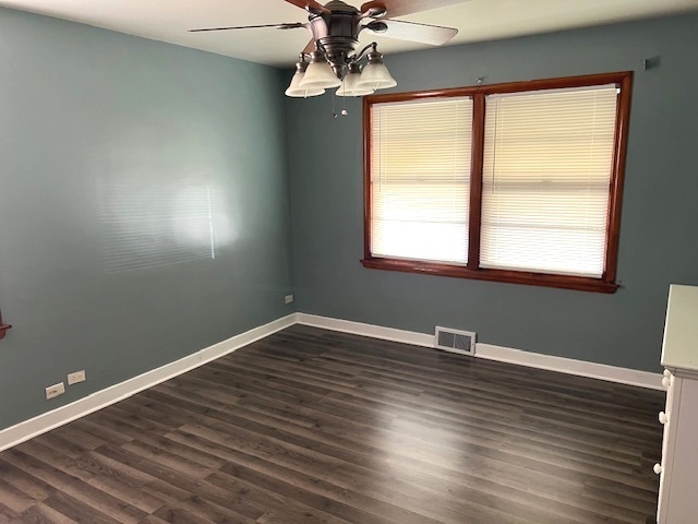 15240 Ashland Avenue Harvey, IL 60426 - Photo 13 of 27 a view of an empty room with wooden floor and a window