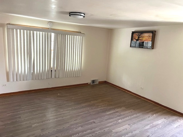 15240 Ashland Avenue Harvey, IL 60426 - Photo 17 of 27 wooden floor in an empty room with a window