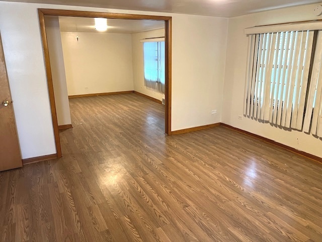 15240 Ashland Avenue Harvey, IL 60426 - Photo 18 of 27 a view of an empty room with wooden floor and a window