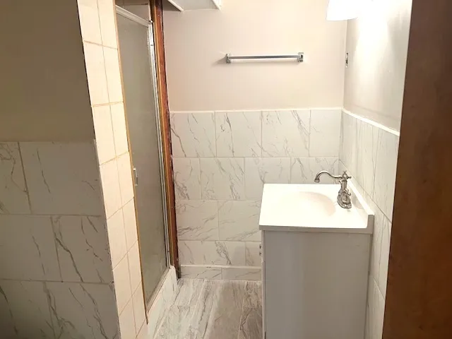 a bathroom with a sink a shower and a mirror
