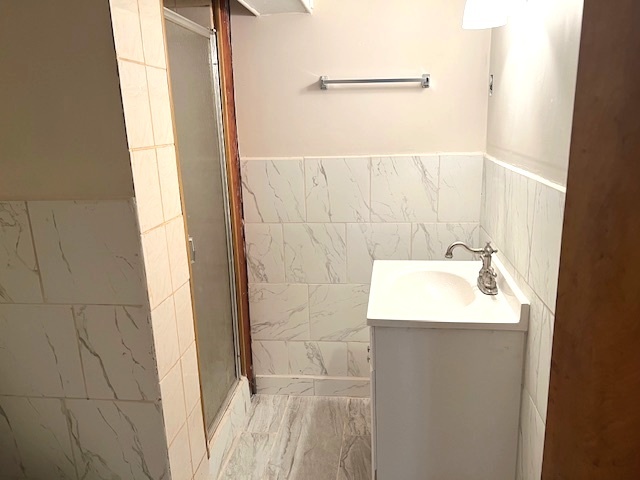 15240 Ashland Avenue Harvey, IL 60426 - Photo 22 of 27 a bathroom with a sink a shower and a mirror