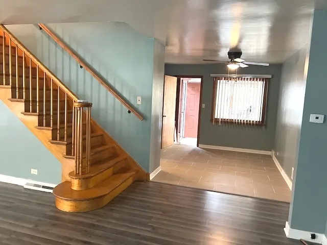 a view of entryway and hall with wooden floor