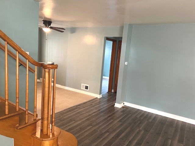 15240 Ashland Avenue Harvey, IL 60426 - Photo 6 of 27 a view of a hallway with wooden floor and staircase