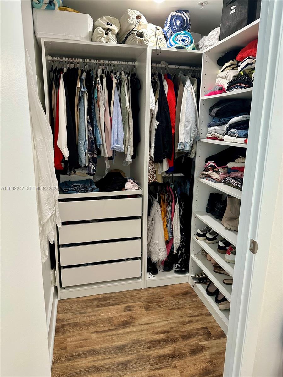 90 Southwest 3rd Street, Unit 2306 Miami, FL 33130 - Photo 11 of 29 a view of walk in closet with clothes and shoes