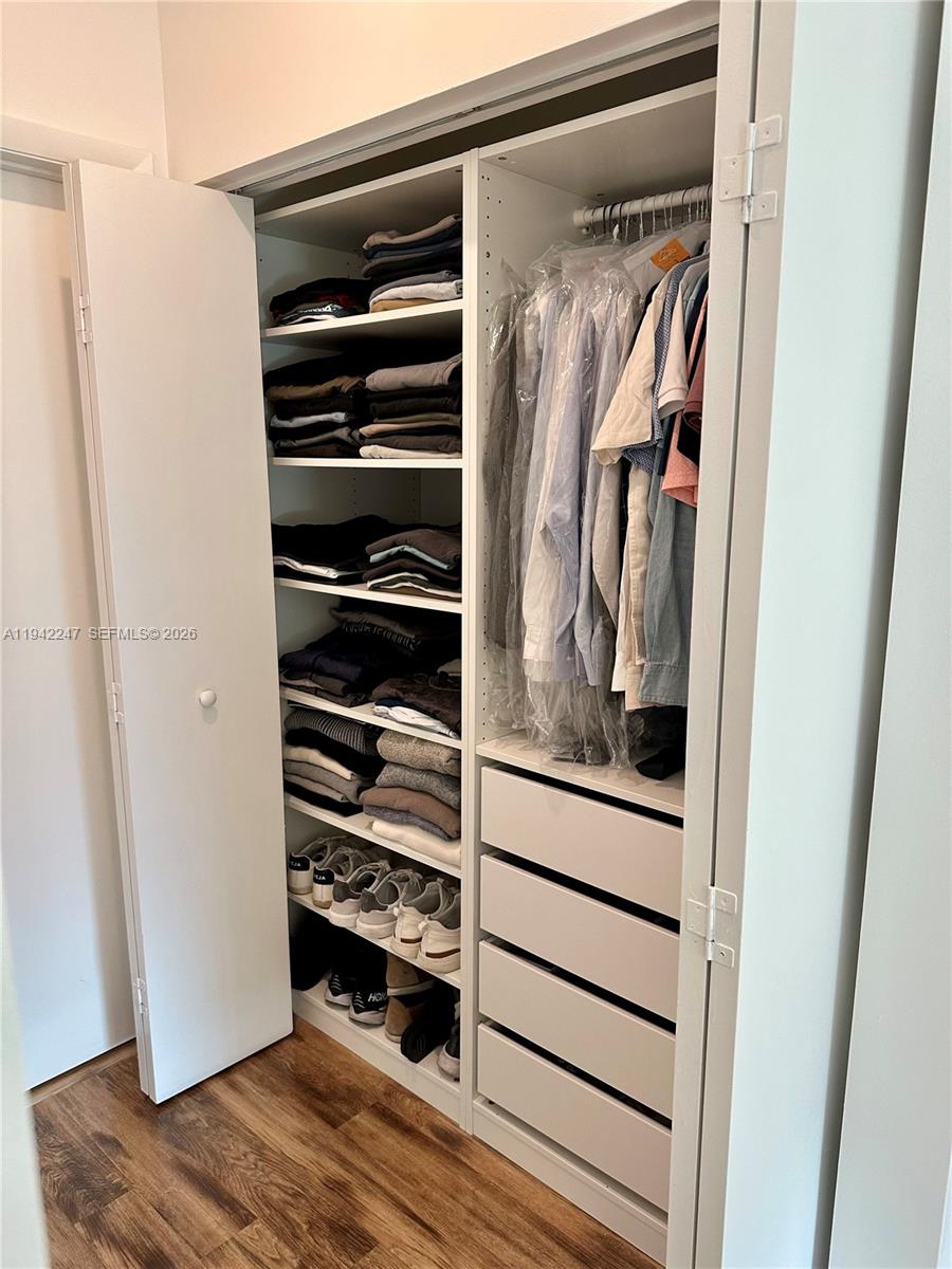 90 Southwest 3rd Street, Unit 2306 Miami, FL 33130 - Photo 12 of 29 a view of walk in closet with clothes and shoes