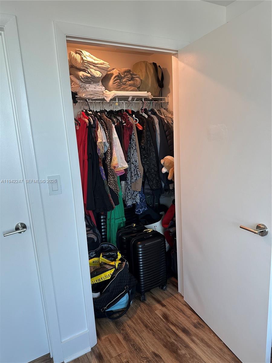 90 Southwest 3rd Street, Unit 2306 Miami, FL 33130 - Photo 15 of 29 a view of walk in closet with clothes and shoes