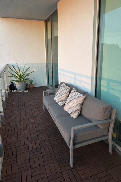 90 Southwest 3rd Street, Unit 2306 Miami, FL 33130 - Photo 18 of 29 a view of a balcony with table and chairs
