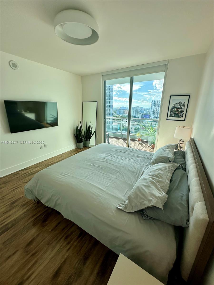 90 Southwest 3rd Street, Unit 2306 Miami, FL 33130 - Photo 8 of 29 a bedroom with a bed and a flat screen tv