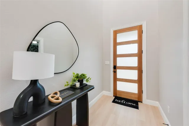 a room with painting on the wall and a window