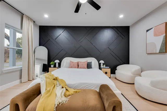 a bedroom with two beds and a large mirror