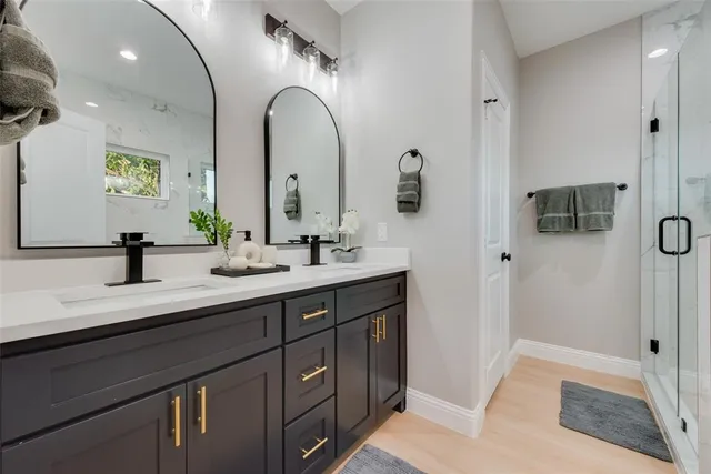 a bathroom with a double vanity sink and a mirror