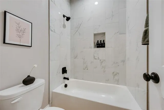 a bathroom with a bathtub and a toilet