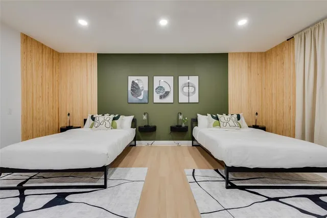 a bedroom with a bed and wooden floor