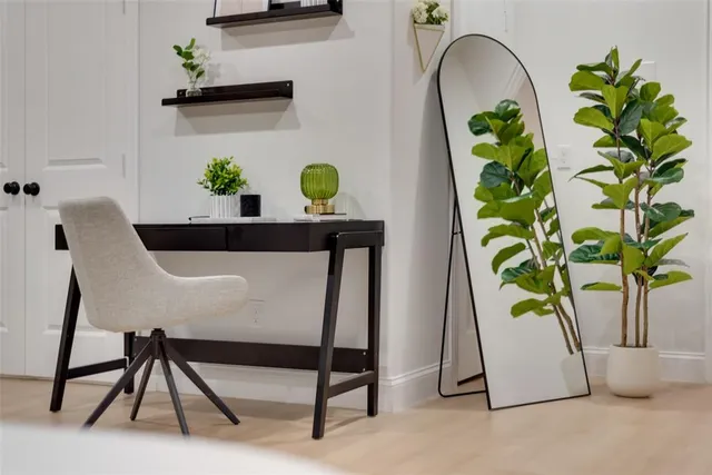 a dining table with potted plants and a chair