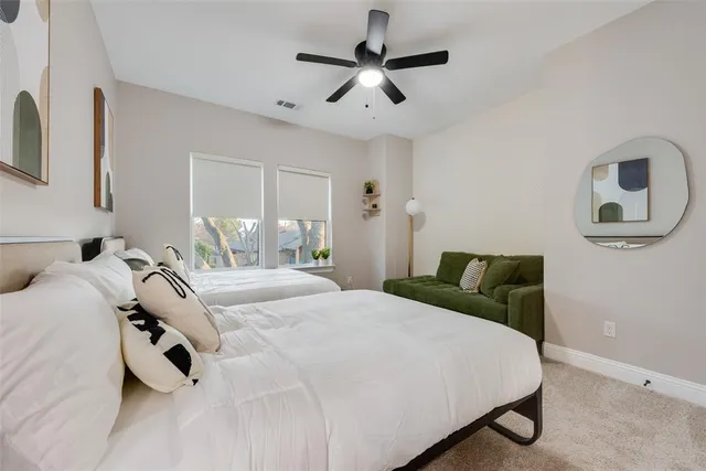 a bathroom with a double vanity sink a toilet and shower