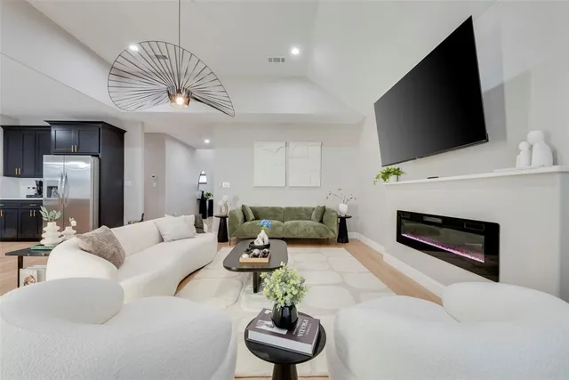 a living room with furniture a fireplace and a flat screen tv